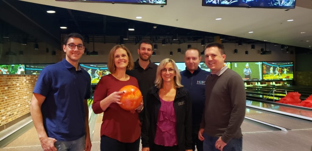 H2R CPA team members split into teams to compete at bowling, laser tag and arcade games.